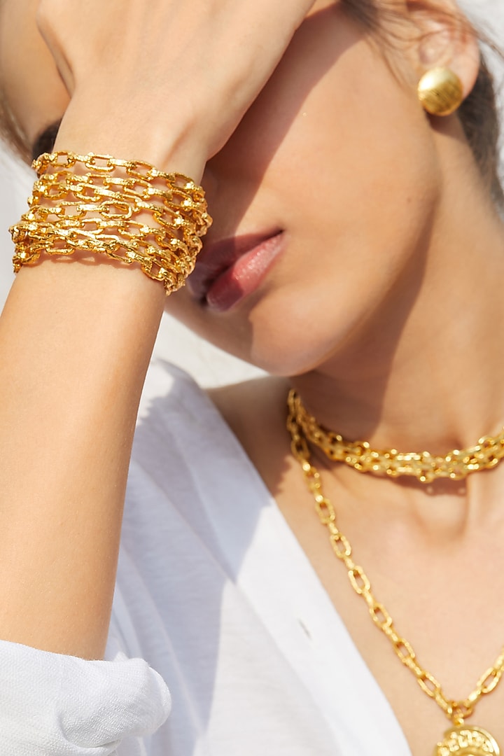 Gold Finish Textured Bangles (Set of 2) by Flowerchild By Shaheen Abbas at Pernia's Pop Up Shop