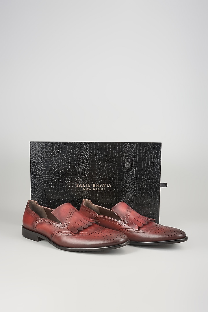 Burgundy Leather Brogue Wingtip Kiltie Slip-On Shoes by SALIL BHATIA at Pernia's Pop Up Shop