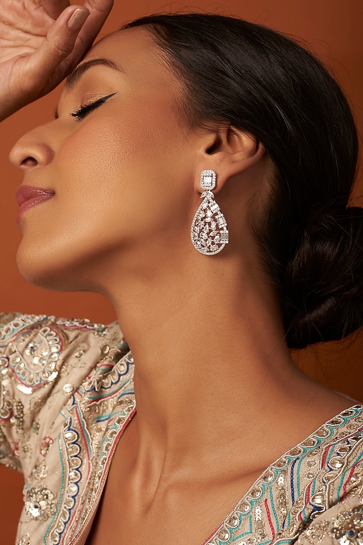 White Finish Dangler Earrings With Zircons by Saga Jewels