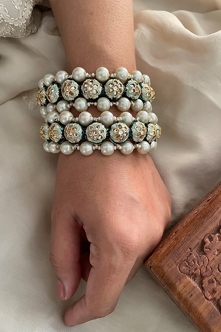 Gold Finish Kundan Polki & Pearl Bangles (Set Of 2) by Saga Jewels at Pernia's Pop Up Shop