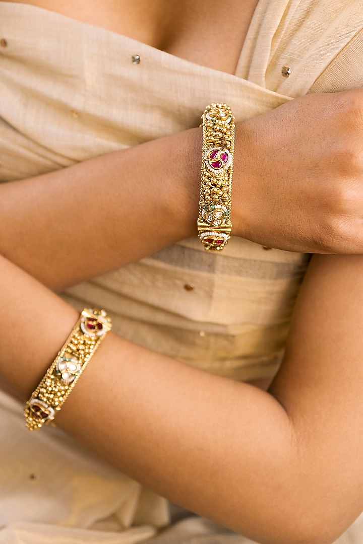Gold Finish Kundan Polki & Ghungroo Temple Bangles (Set Of 2) by Saga Jewels at Pernia's Pop Up Shop