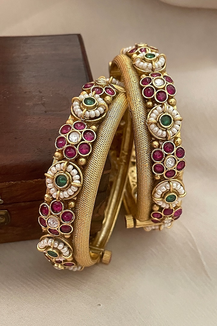 Gold Finish Pearl Temple Bangles (Set Of 2) by Saga Jewels at Pernia's Pop Up Shop