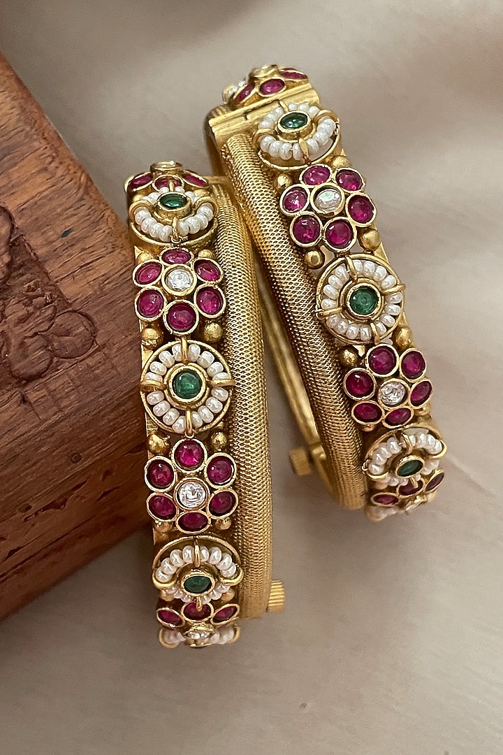 Gold Finish Pearl Temple Bangles (Set Of 2) by Saga Jewels at Pernia's Pop Up Shop