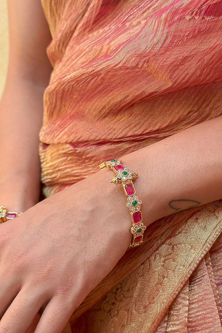 Gold Finish Red Stone & Floral Motif Bangles (Set Of 2) by Saga Jewels at Pernia's Pop Up Shop