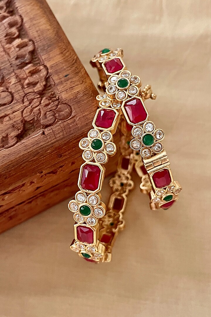 Gold Finish Red Stone & Floral Motif Bangles (Set Of 2) by Saga Jewels at Pernia's Pop Up Shop