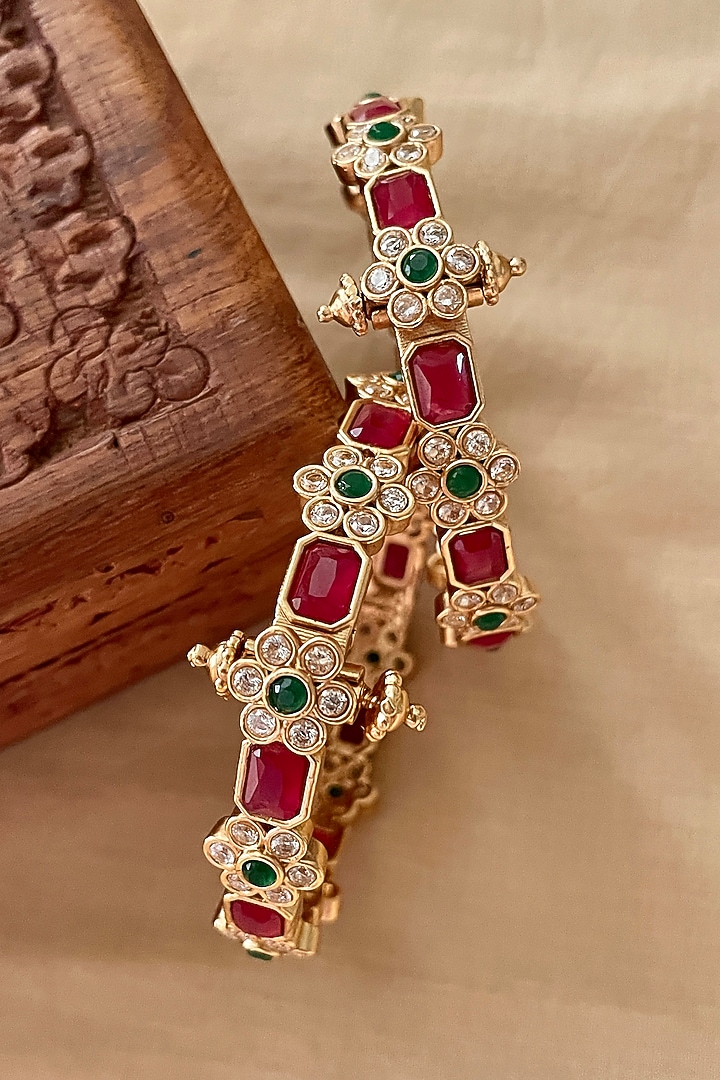 Gold Finish Red Stone & Floral Motif Bangles (Set Of 2) by Saga Jewels at Pernia's Pop Up Shop