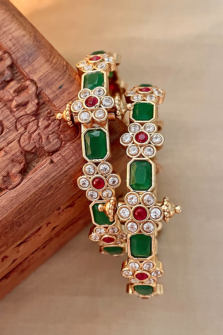 Gold Finish Green Stone & Floral Motif Bangles (Set Of 2) by Saga Jewels at Pernia's Pop Up Shop