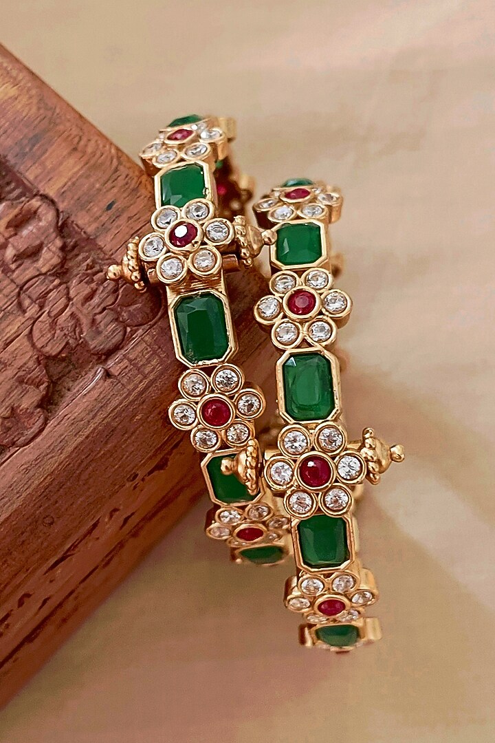 Gold Finish Green Stone & Floral Motif Bangles (Set Of 2) by Saga Jewels at Pernia's Pop Up Shop