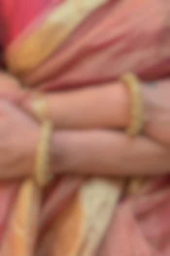 Gold Finish Temple Carved Bangles (Set Of 2) by Saga Jewels at Pernia's Pop Up Shop