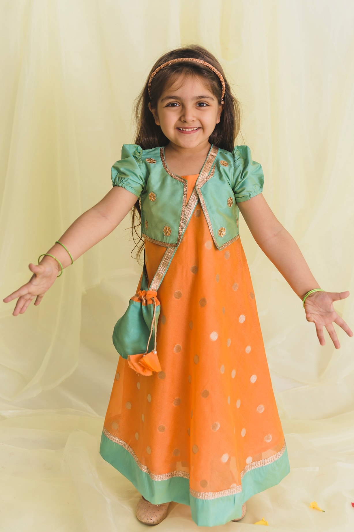 Rust Orange And Green Gown With Potli Bag For Girls by Saka