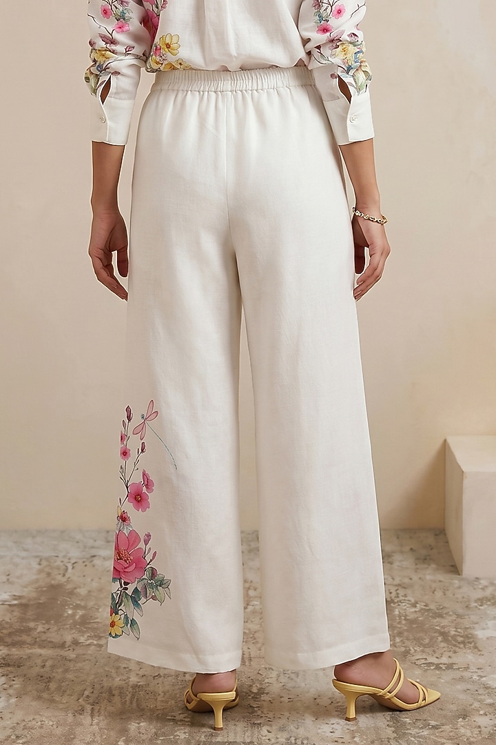 Off-White Linen Floral Motif Printed Pants by Satya Paul at Pernia's Pop Up Shop