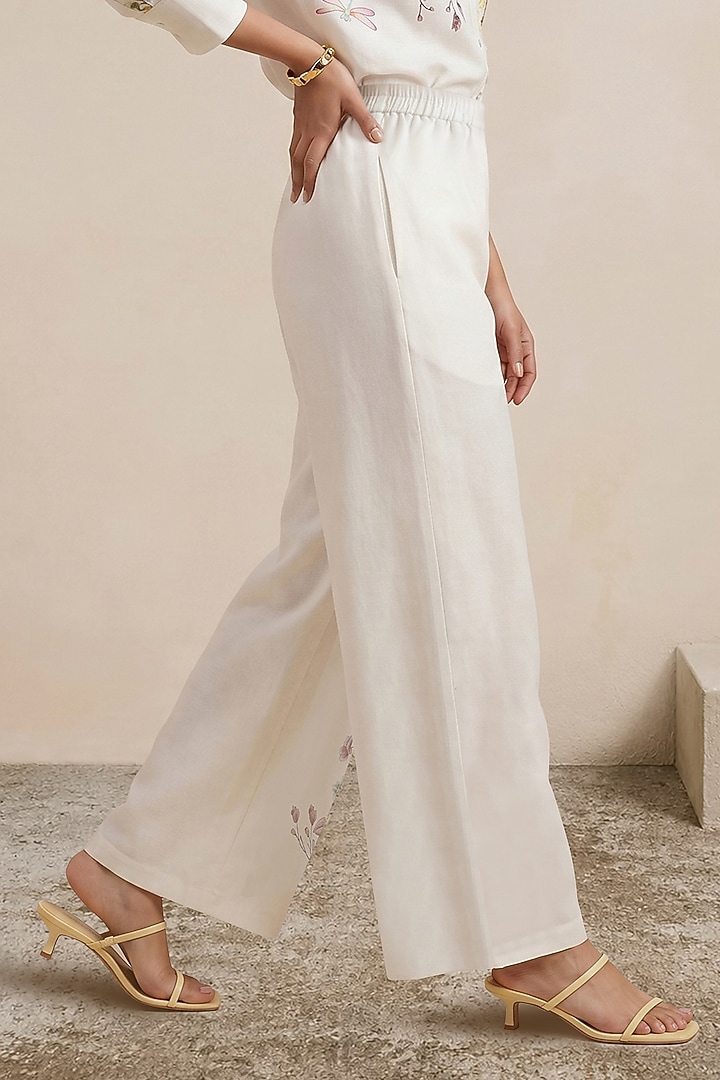 Off-White Linen Floral Motif Printed Pants by Satya Paul at Pernia's Pop Up Shop