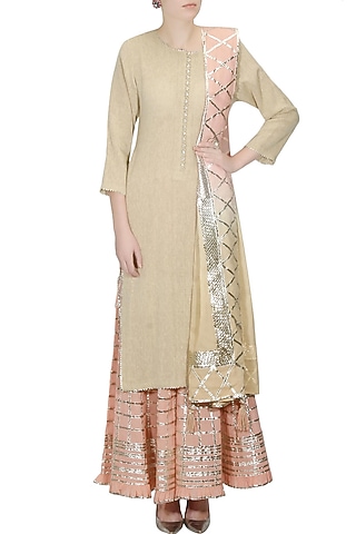 Beige gota patti work kurta and peach sharara pants set by Sukriti & Aakriti