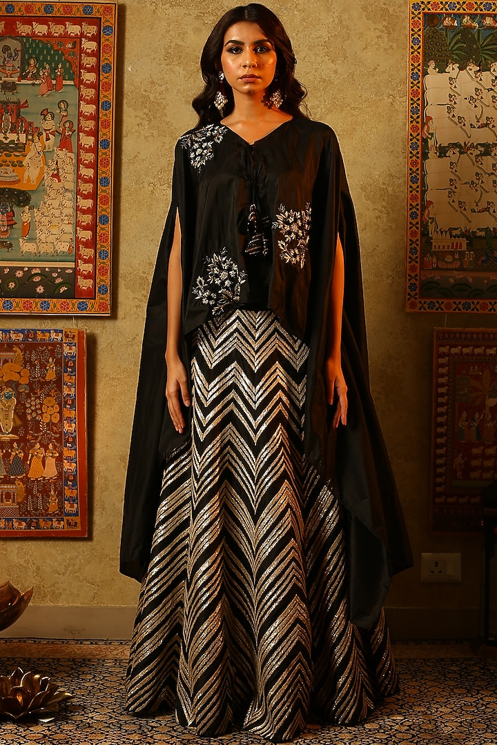 Black embroidered lehenga skirt with asymmetrical cape available only at Pernia's Pop Up Shop.