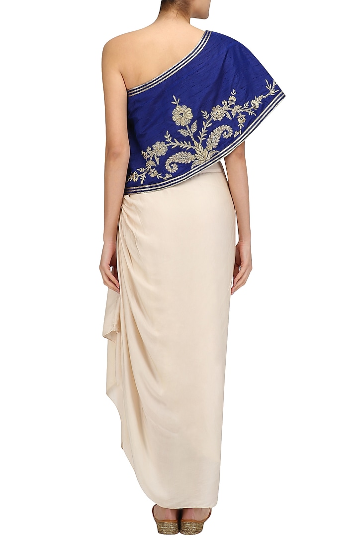 Blue floral embroidered one shoulder top with cream drape skirt available only at Pernia's Pop Up Shop.