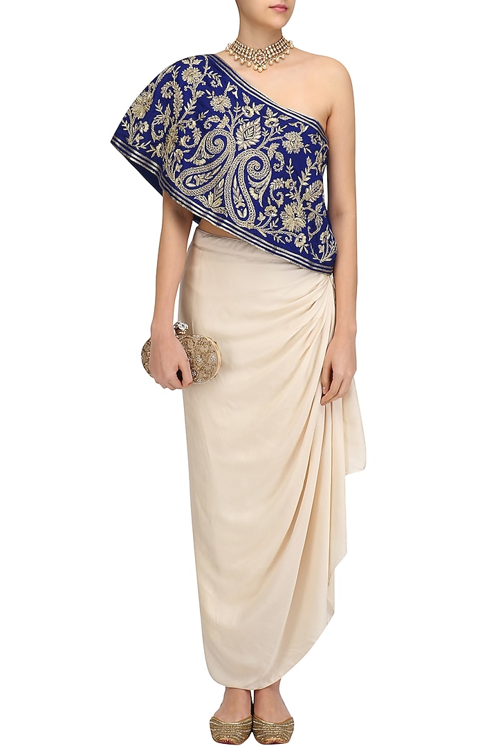 Blue floral embroidered one shoulder top with cream drape skirt available only at Pernia's Pop Up Shop.