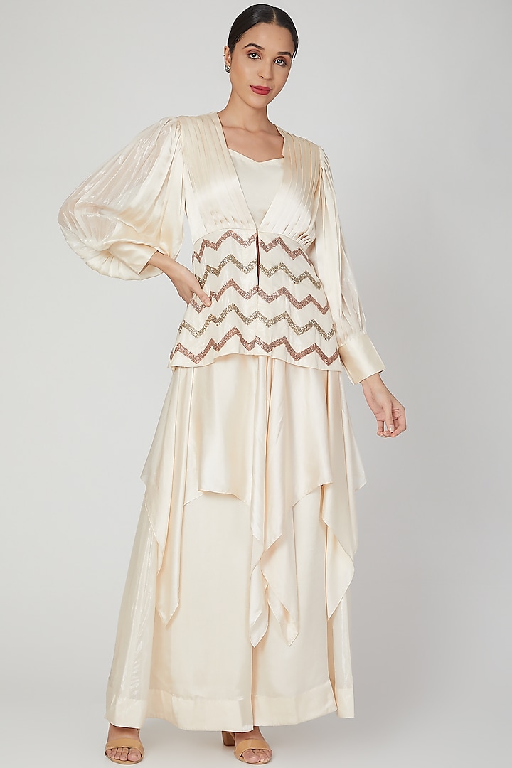 Cream Sequins Embroidered Peplum Top With Tube & Pants by Siyona By Ankurita
