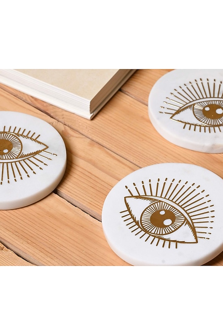 White Marble & Metal Evil Eye Round Coasters ( Set Of 4 ) by Serein Wellness at Pernia's Pop Up Shop