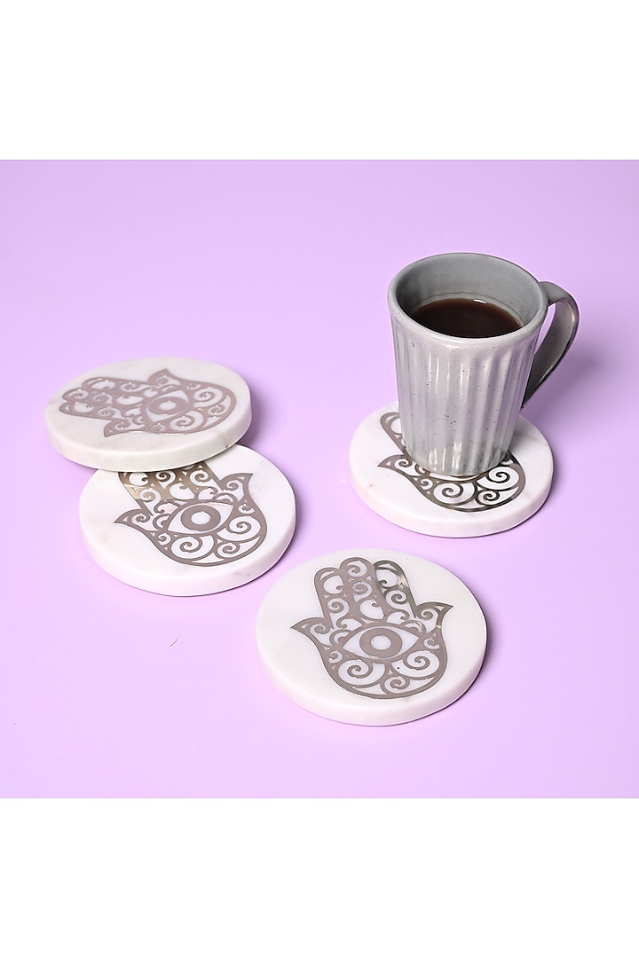 White Marble & Metal Hamsa Round Coasters ( Set Of 4 ) by Serein Wellness at Pernia's Pop Up Shop