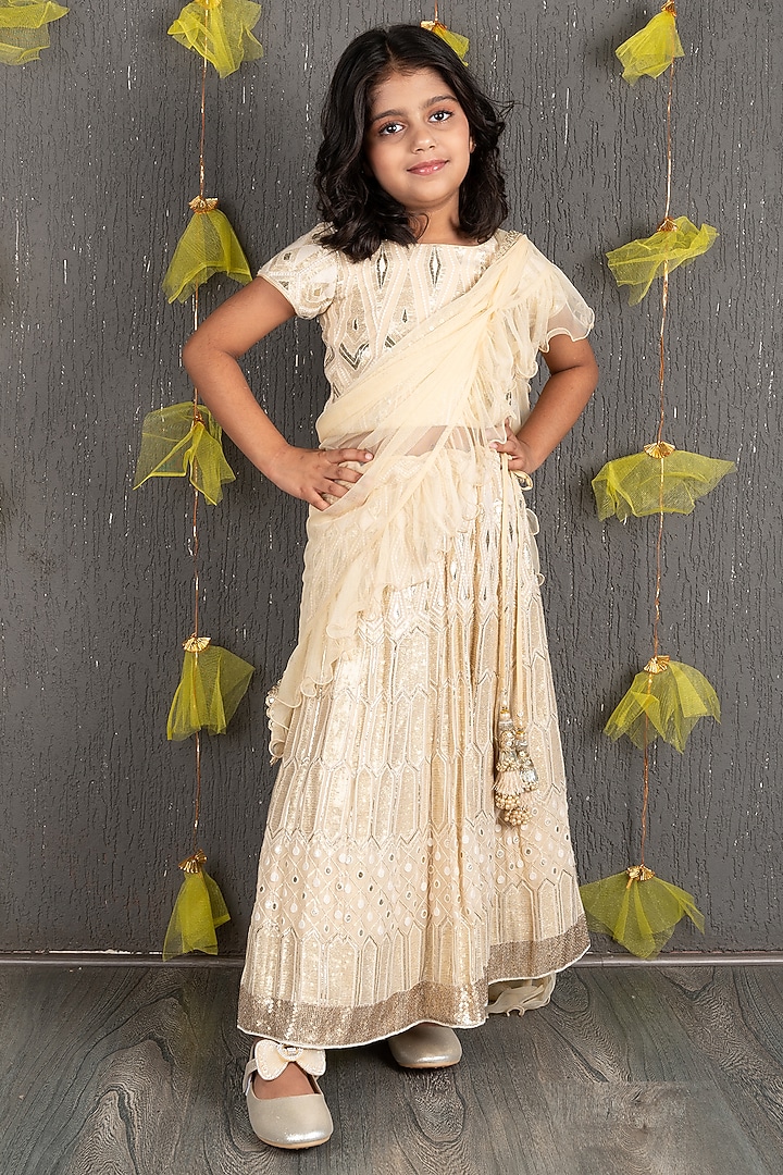 Champagne Gold Net Embroidered Lehenga Set For Girls by SHRUTI JALAN at Pernia's Pop Up Shop