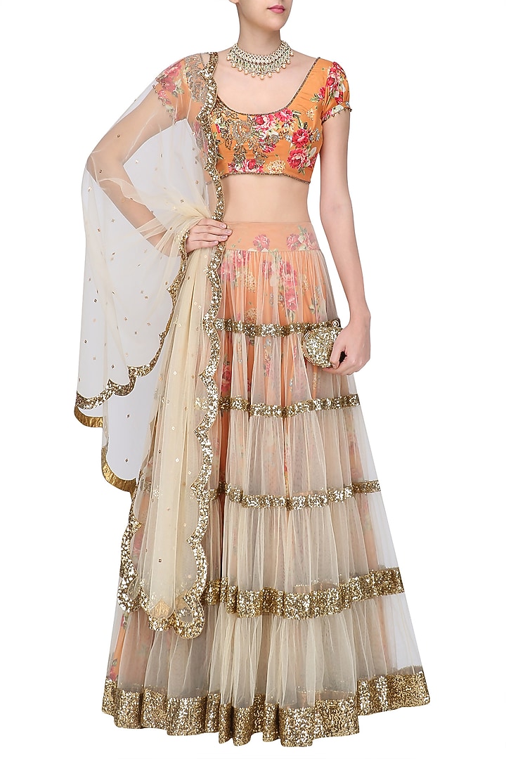 Beige lehenga skirt and orange floral embroidered blouse set available only at Pernia's Pop Up Shop.