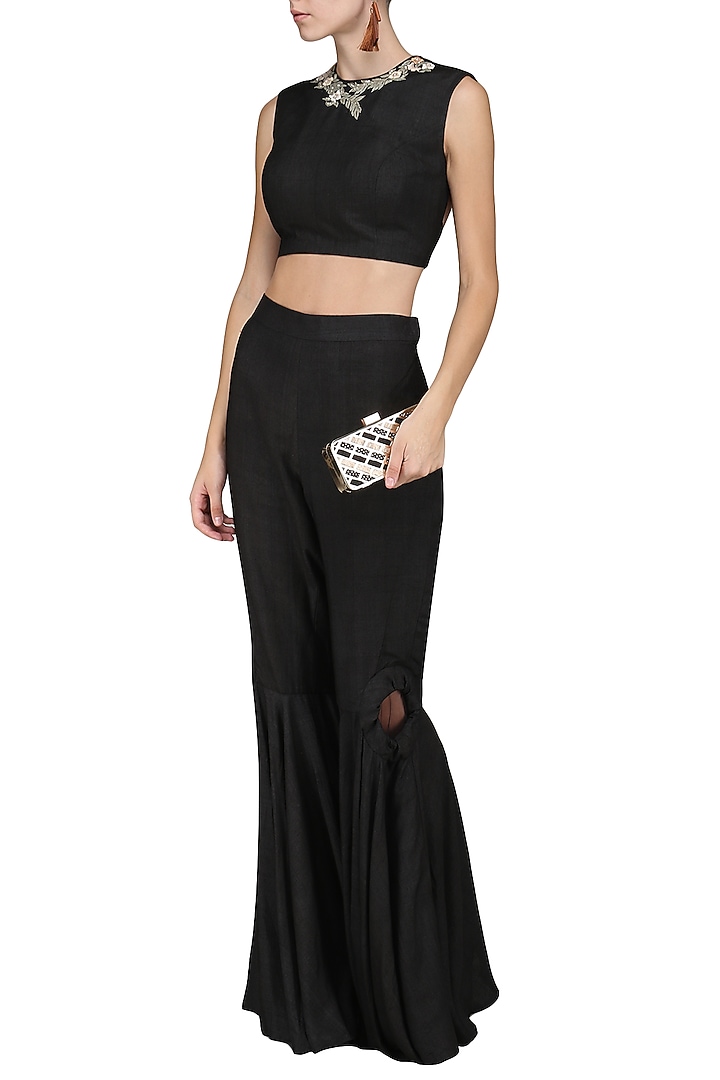 Black embroidered crop top with flared pants available only at Pernia's Pop Up Shop.