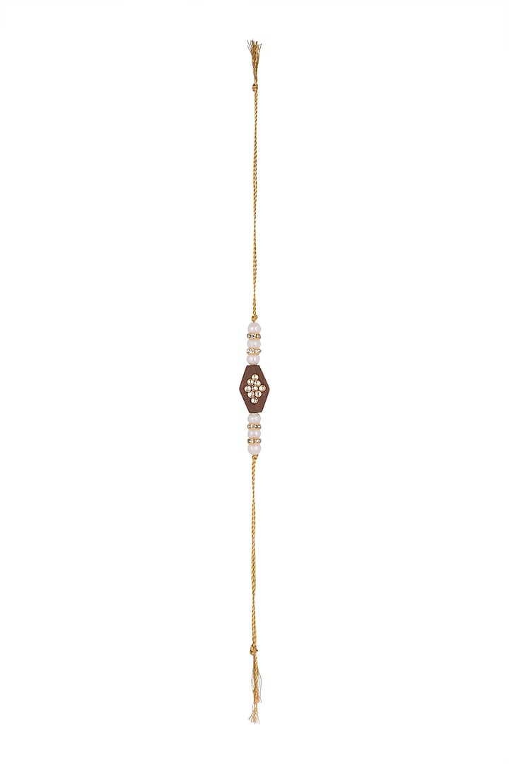 Gold Finish Pearl Rakhi With Wooden Base by SONNET at Pernia's Pop Up Shop