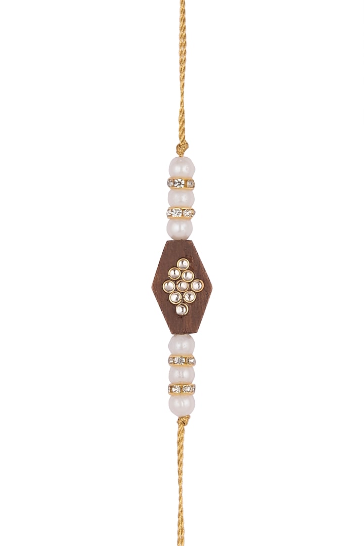 Gold Finish Pearl Rakhi With Wooden Base by SONNET