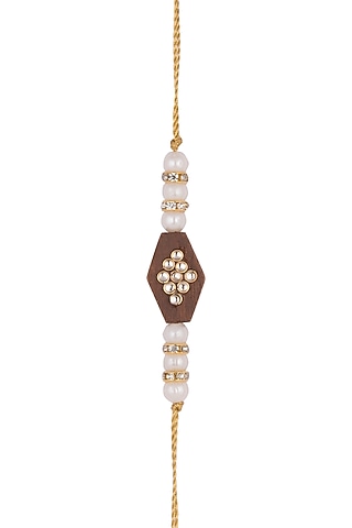 Gold Finish Pearl Rakhi With Wooden Base by SONNET