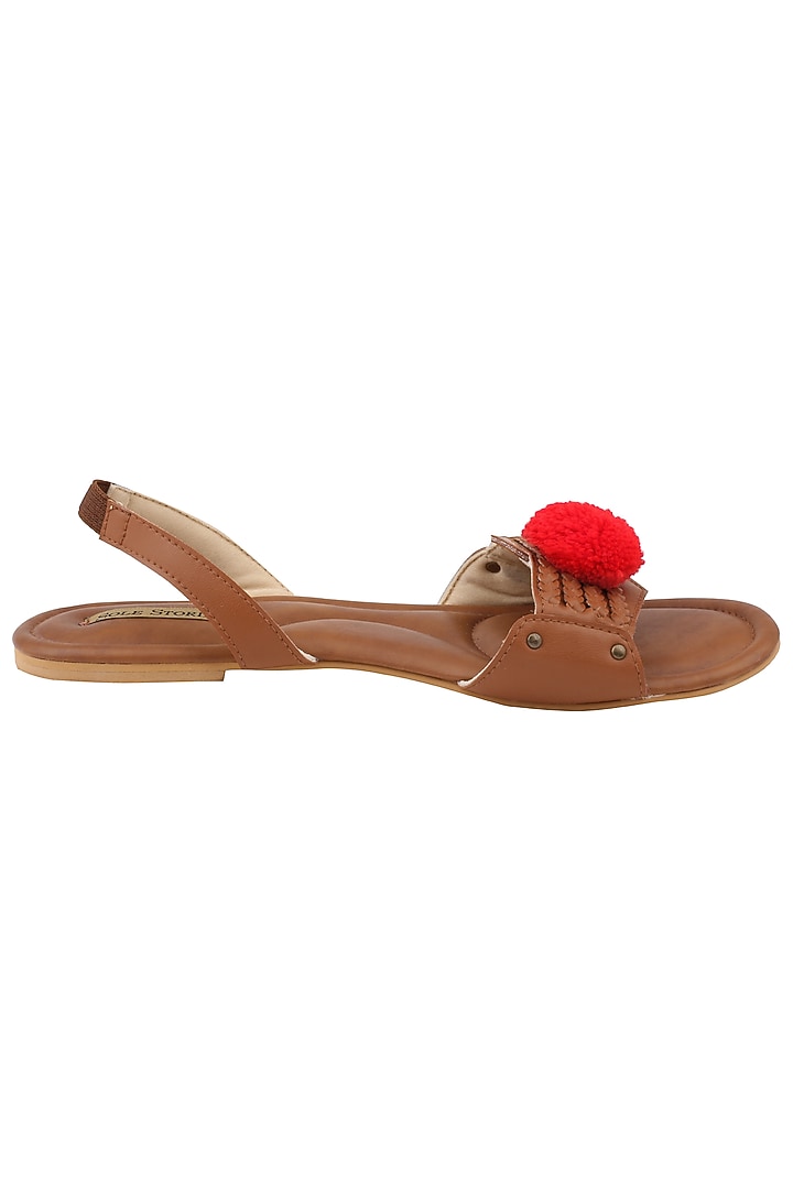 Tan pom pom embellished sandals available only at Pernia's Pop Up Shop.