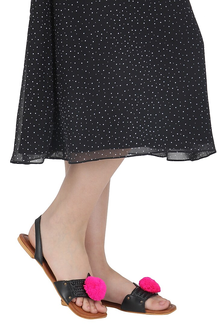 Black pom pom embellished sandals available only at Pernia's Pop Up Shop.