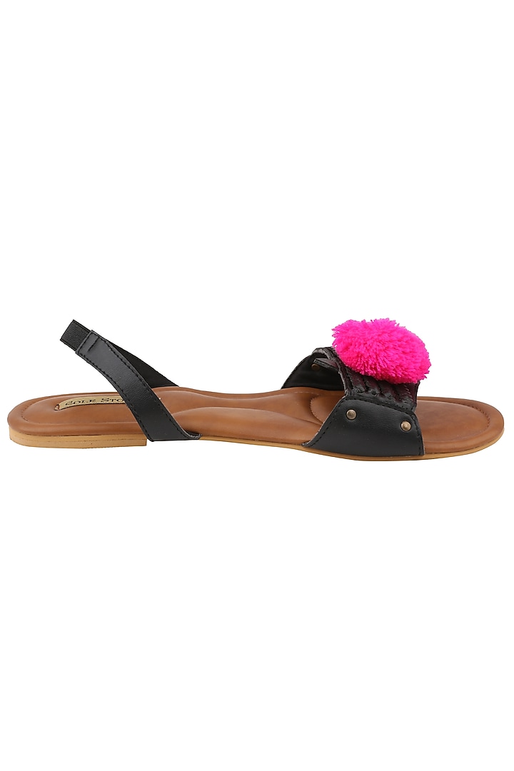 Black pom pom embellished sandals available only at Pernia's Pop Up Shop.