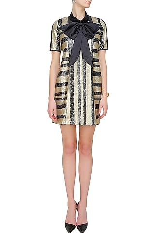 Black and gold striped shift dress with a dramatic bow by Sonam Parmar