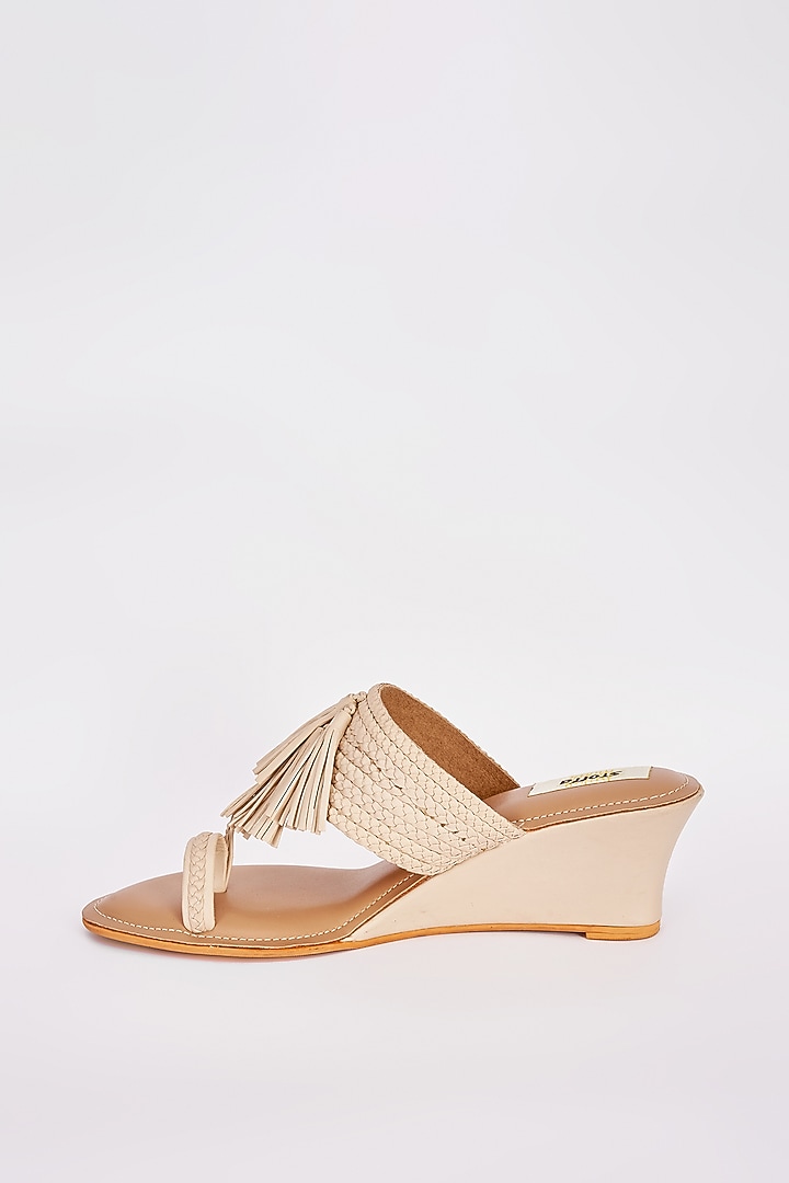 Beige Faux Leather Tasseled Wedges by Stoffa Bride at Pernia's Pop Up Shop