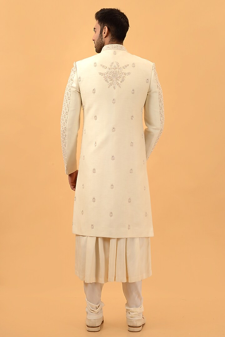 Cream Raw Silk Hand & Machine Embroidered Groom Sherwani Set by STEEL at Pernia's Pop Up Shop