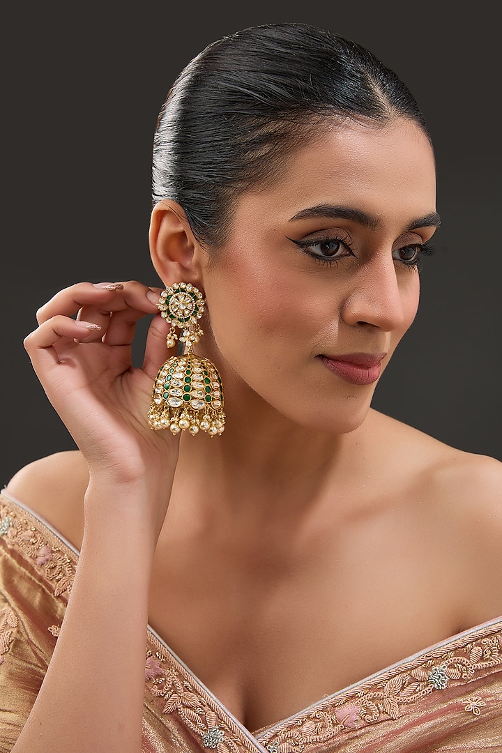 Gold Finish Moissanite Polki & Synthetic Emerald Stone Jhumka Earrings In Sterling Silver by STELLA CREATIONS