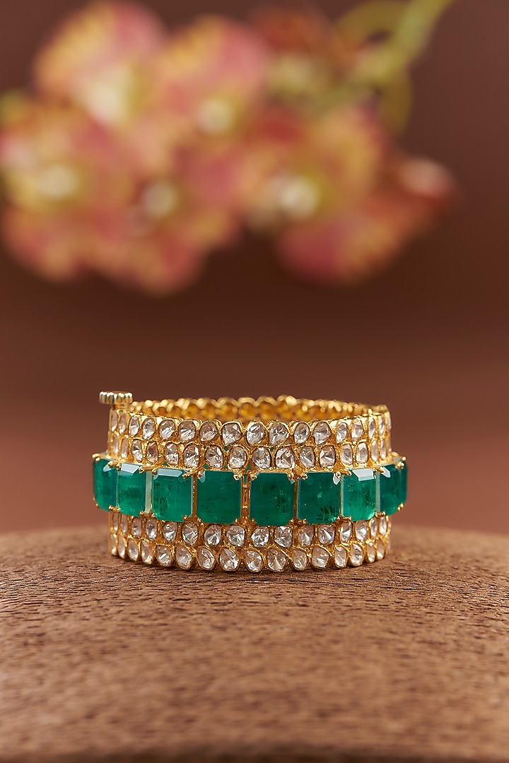 Gold Finish Moissanite Polki & Synthetic Emerald Bangle In Sterling Silver by STELLA CREATIONS at Pernia's Pop Up Shop
