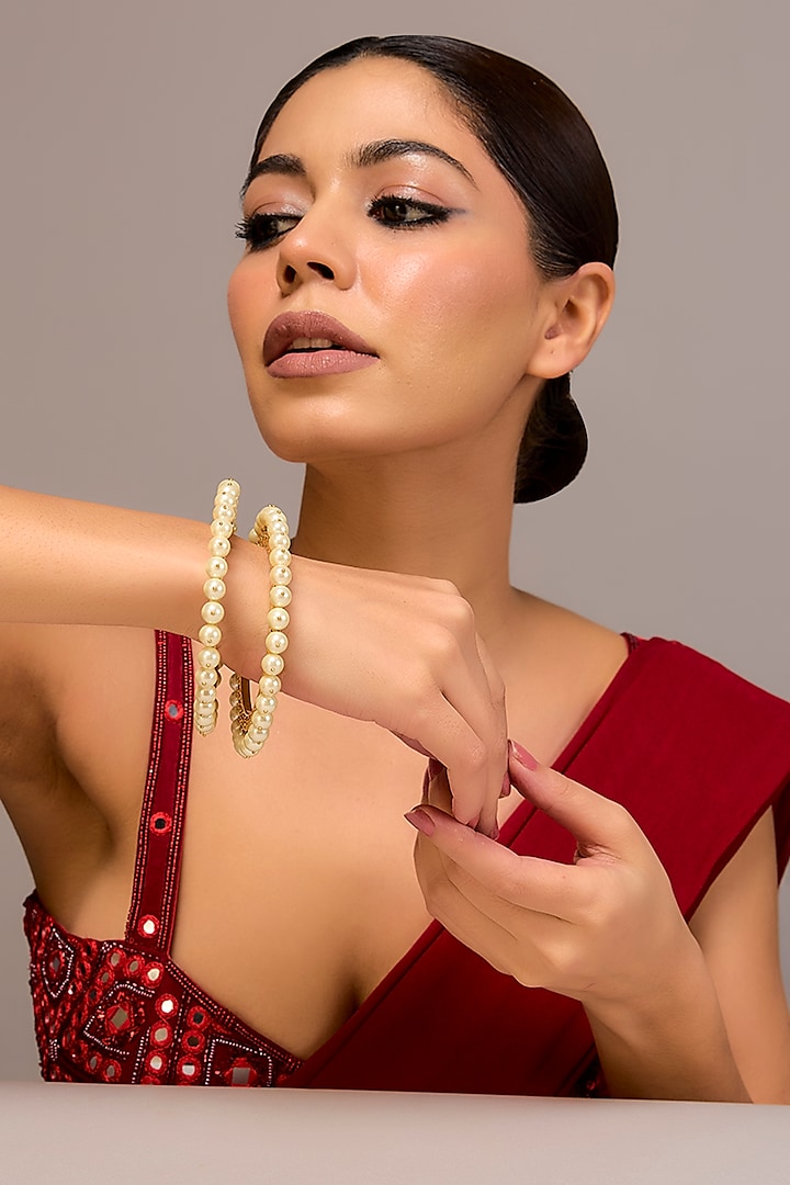 Gold Finish White Pearl Bangles In Sterling Silver (Set Of 2) by STELLA CREATIONS at Pernia's Pop Up Shop