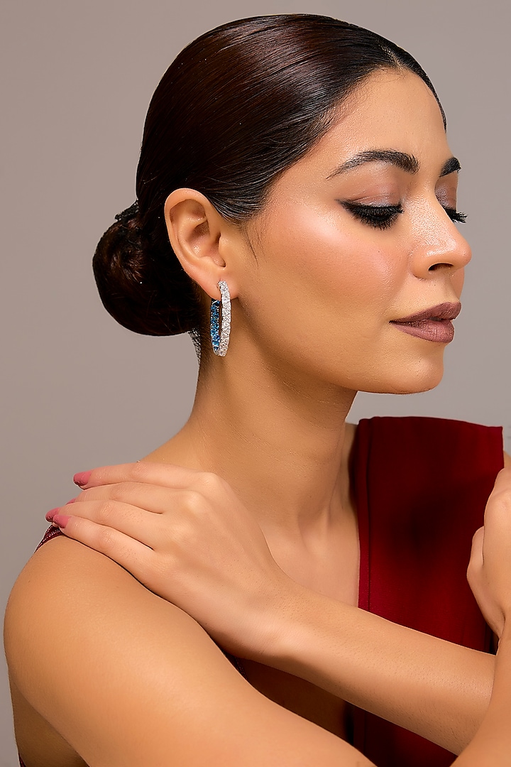 White Finish Zircon & Blue Stone Hoop Earrings In Sterling Silver by STELLA CREATIONS at Pernia's Pop Up Shop