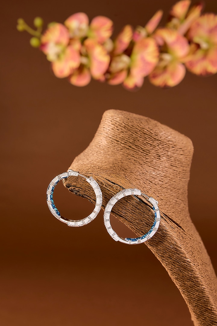 White Finish Zircon & Blue Stone Hoop Earrings In Sterling Silver by STELLA CREATIONS at Pernia's Pop Up Shop
