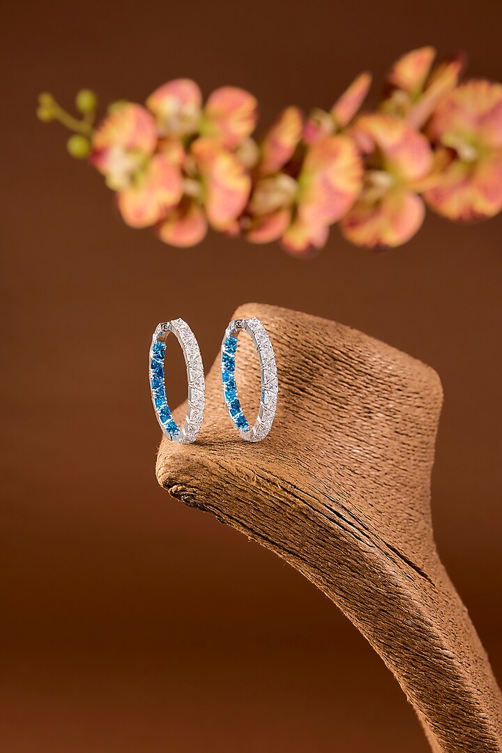 White Finish Zircon & Blue Stone Hoop Earrings In Sterling Silver by STELLA CREATIONS at Pernia's Pop Up Shop