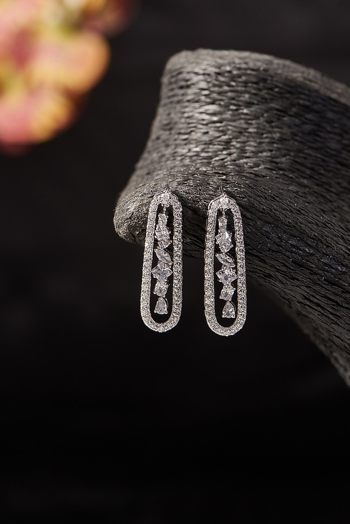 White Finish CZ Dangler Earrings In Sterling Silver by STELLA CREATIONS at Pernia's Pop Up Shop