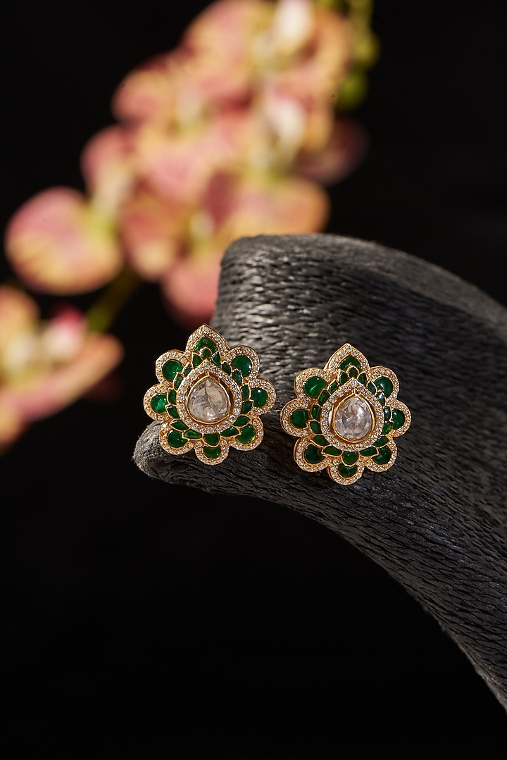 Gold Finish Synthetic Emerald Stone & Moissanite Polki Stud Earrings In Sterling Silver by STELLA CREATIONS at Pernia's Pop Up Shop