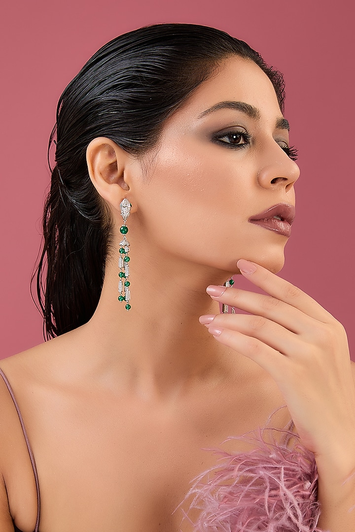 White Finish Zircon & Emerald Dangler Earrings In Sterling Silver by STELLA CREATIONS at Pernia's Pop Up Shop