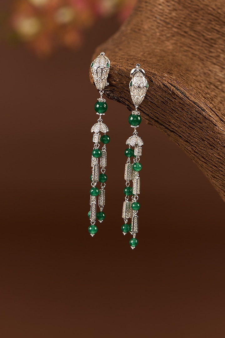 White Finish Zircon & Emerald Dangler Earrings In Sterling Silver by STELLA CREATIONS at Pernia's Pop Up Shop