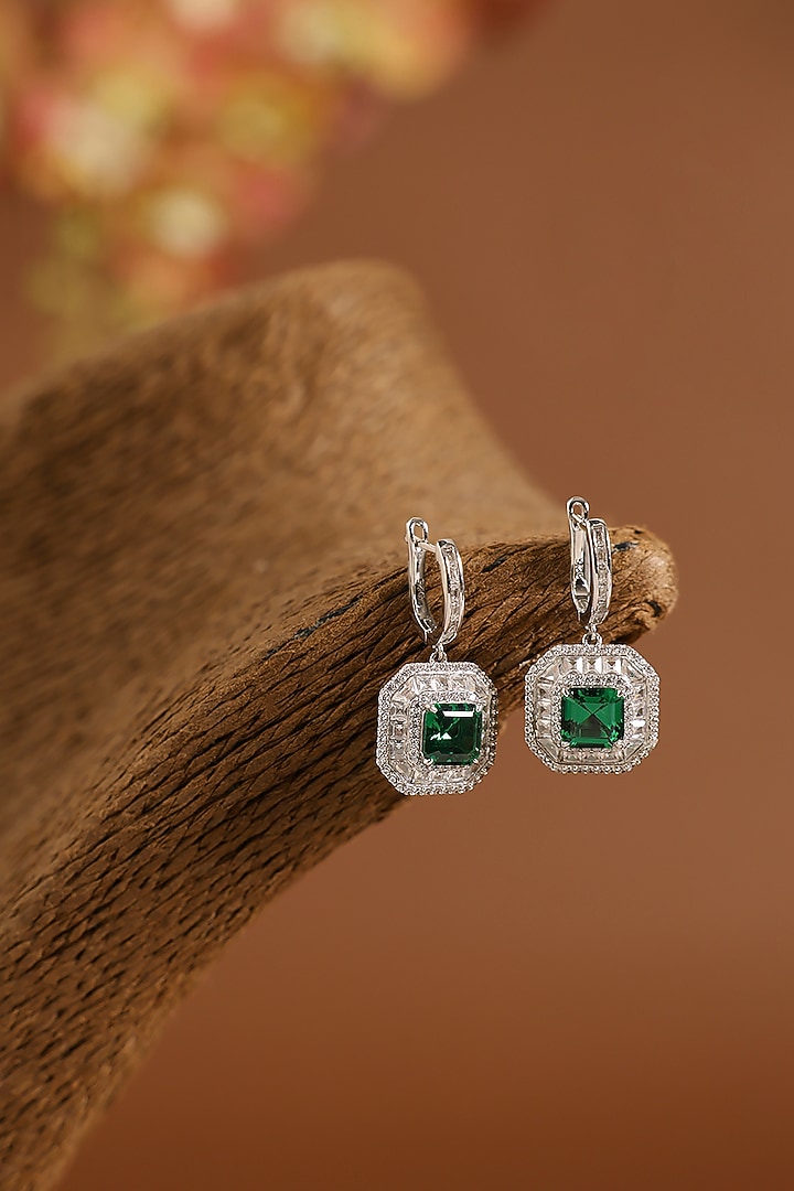 White Gold Finish Swarovski & Emerald Dangler Earrings In Sterling Silver by STELLA CREATIONS at Pernia's Pop Up Shop