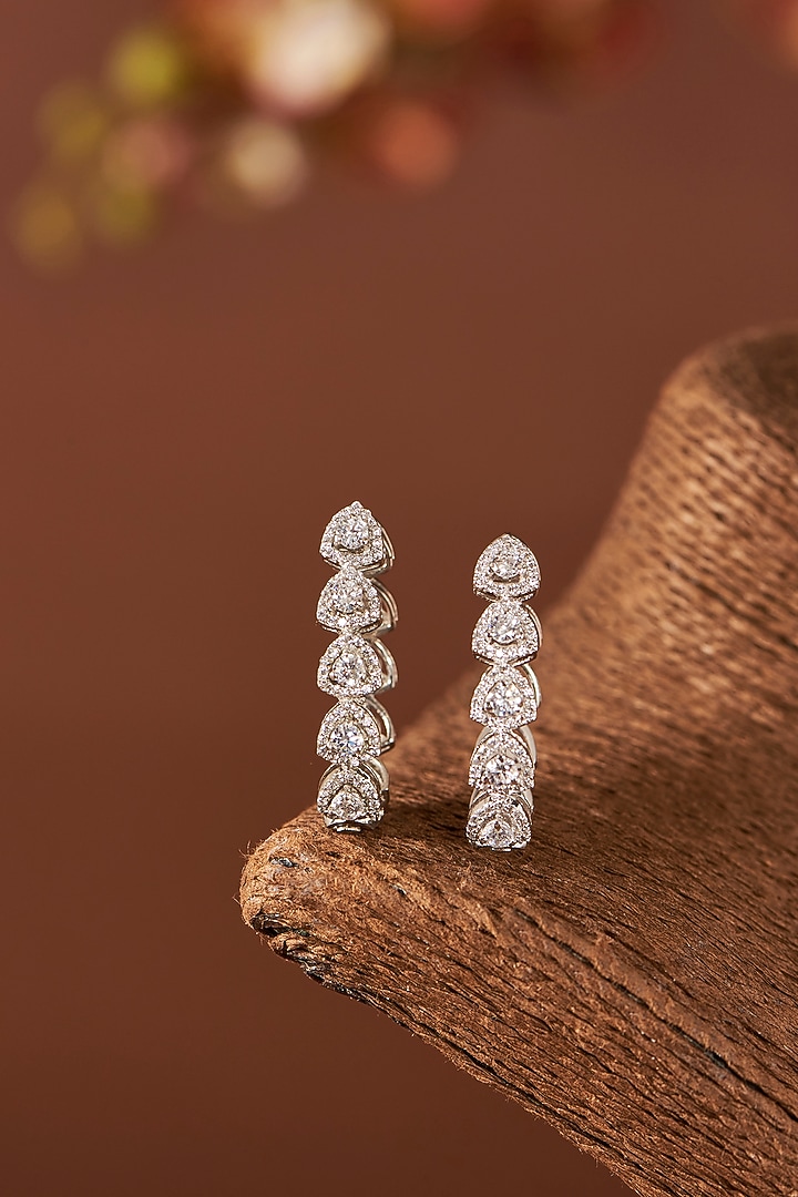 White Finish Eurostar Zircon Hoop Earrings In Sterling Silver by STELLA CREATIONS at Pernia's Pop Up Shop