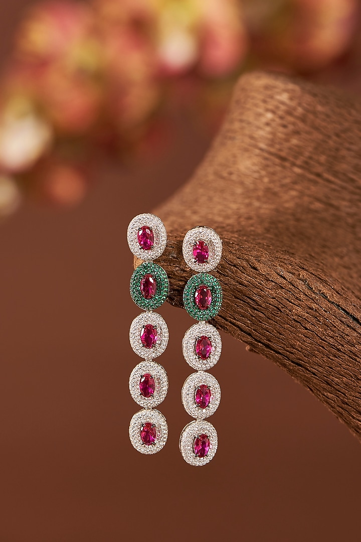 White Finish Eurostar Zirconia & Ruby Dangler Earrings In Sterling Silver by STELLA CREATIONS at Pernia's Pop Up Shop