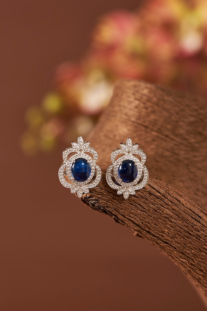 White Finish Eurostar Zirconia & Blue Sapphire Stud Earrings In Sterling Silver by STELLA CREATIONS at Pernia's Pop Up Shop