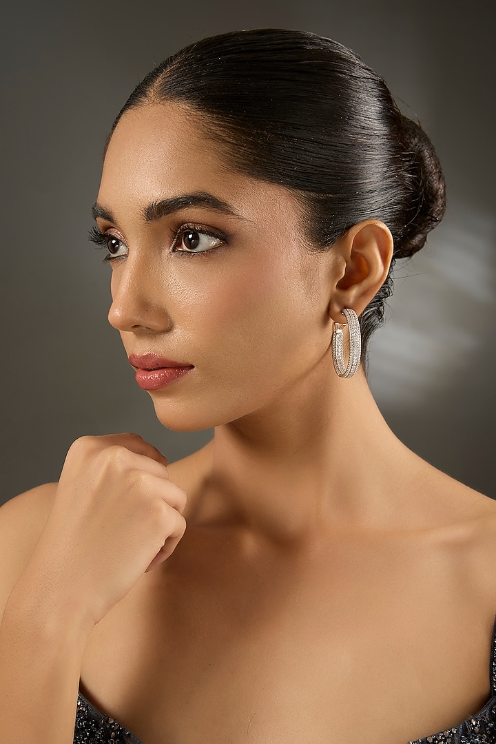 White Gold Finish Eurostar Zircon Hoop Earrings In Sterling Silver by STELLA CREATIONS at Pernia's Pop Up Shop